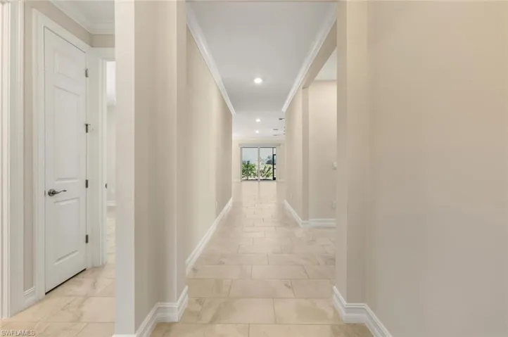 Hall featuring ornamental molding and recessed lighting