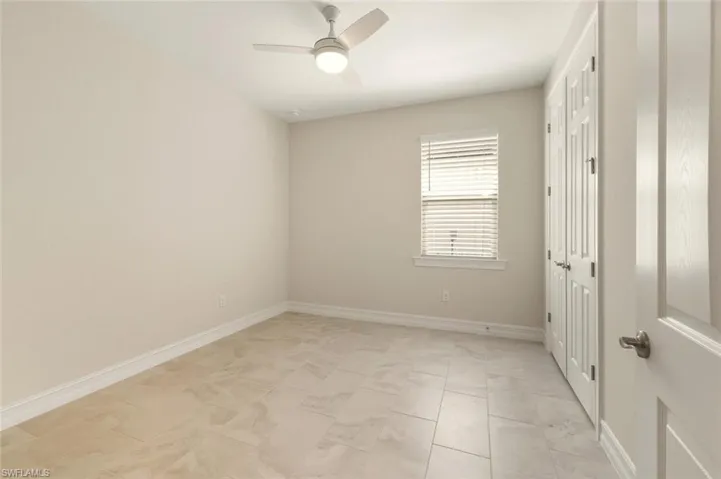 Unfurnished bedroom featuring ceiling fan and a closet