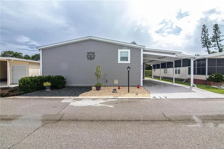 View of home's exterior featuring concrete driveway