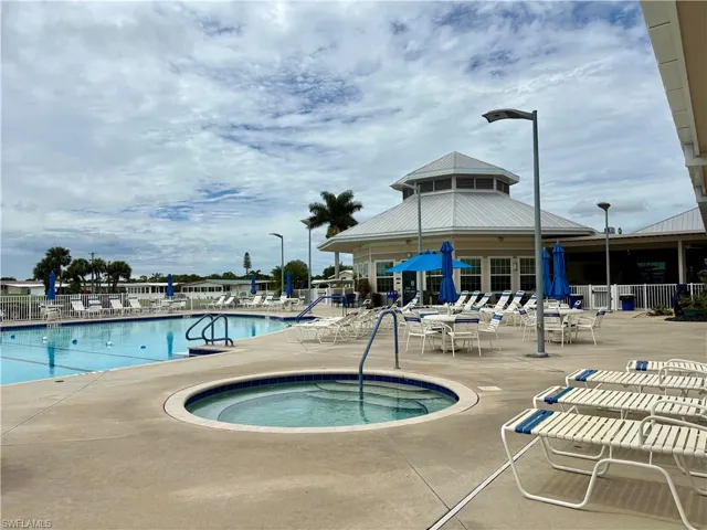 Community pool with a community hot tub and a patio area