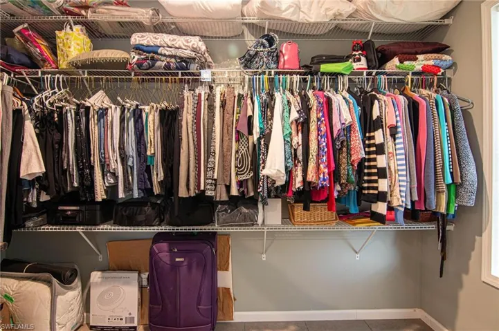 Spacious closet featuring tile patterned flooring