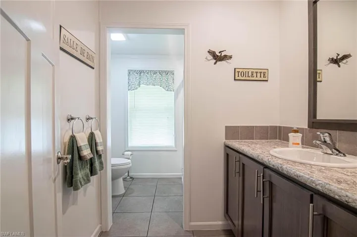 Bathroom with vanity and light tile patterned flooring