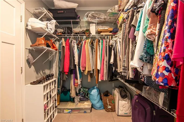 Walk in closet featuring light tile patterned flooring