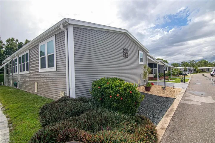 View of property exterior featuring a yard