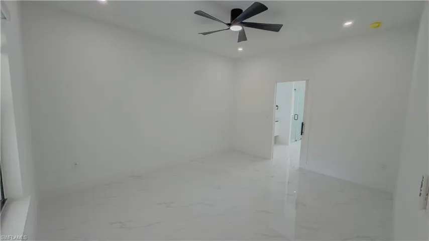 Spare room featuring light marble finish flooring, recessed lighting, and a ceiling fan