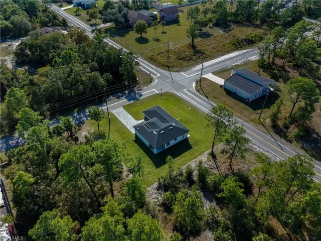 View from above of property with a tree filled landscape