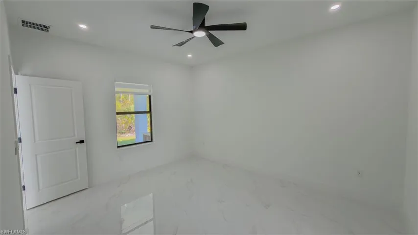 Unfurnished room with light marble finish flooring, recessed lighting, and ceiling fan