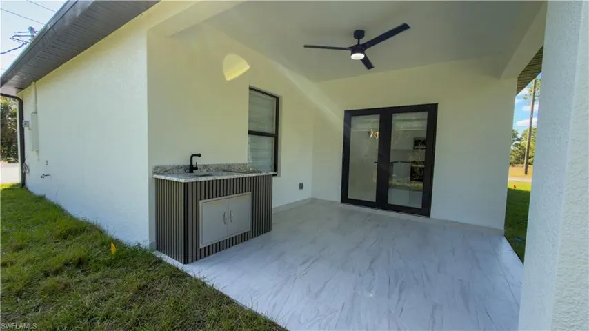 View of patio featuring french doors and a ceiling fan