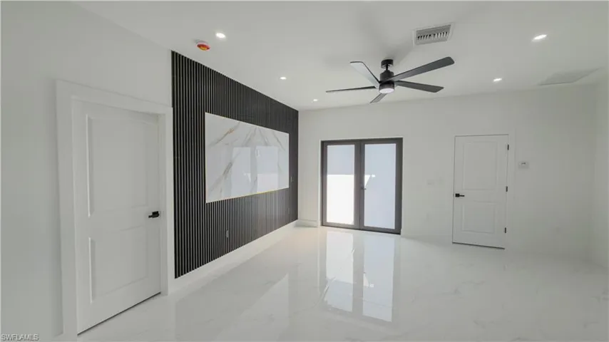 Unfurnished room with recessed lighting, french doors, ceiling fan, and light marble finish flooring