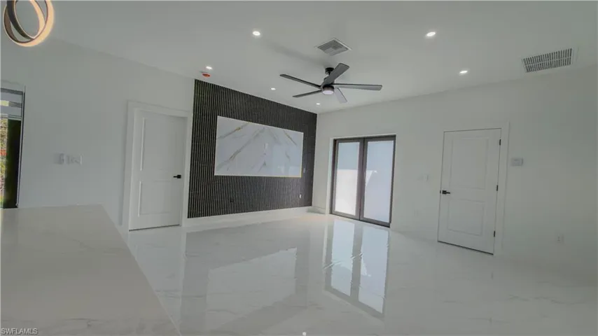 Empty room featuring light marble finish floors, recessed lighting, and a ceiling fan