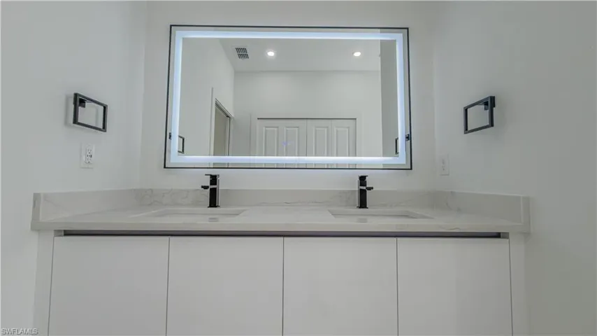 Full bath featuring double vanity and recessed lighting
