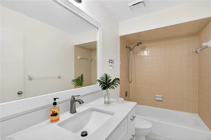 Bathroom featuring washtub / shower combination and vanity