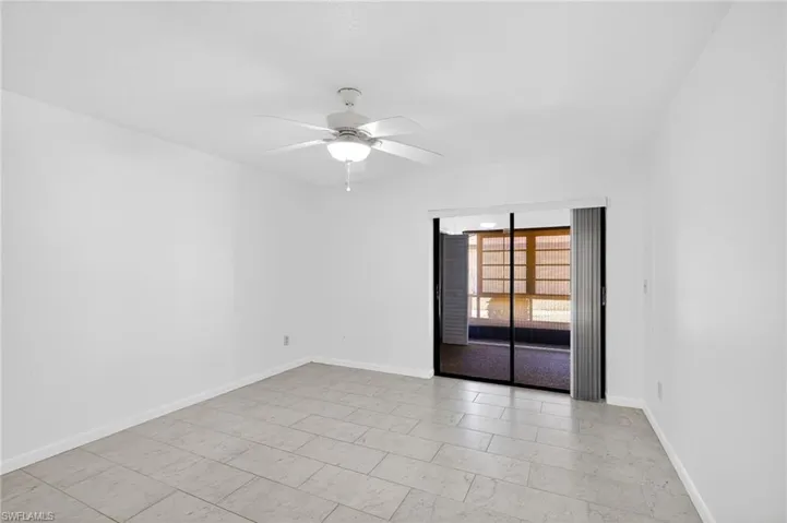 Spare room with a ceiling fan and baseboards
