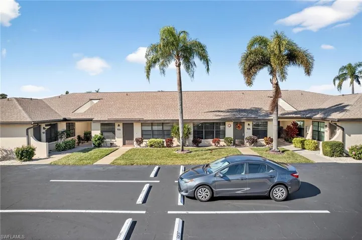 View of front of house with a shingled roof and uncovered parking