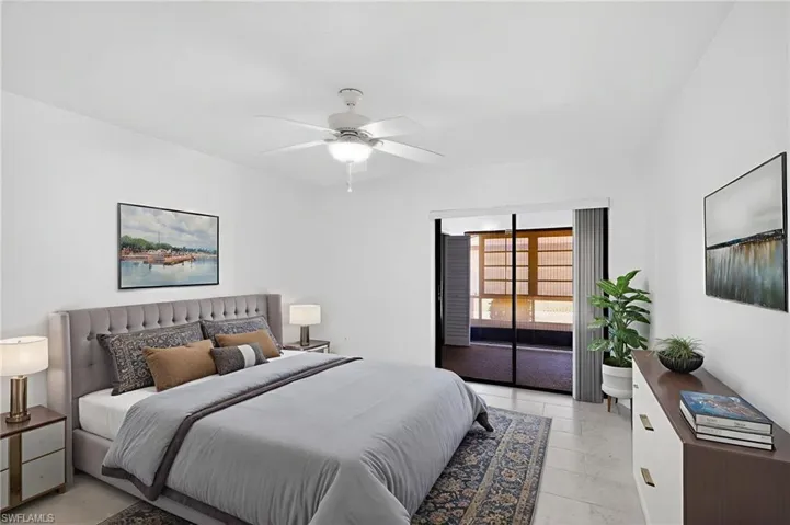 Bedroom featuring a ceiling fan and access to exterior