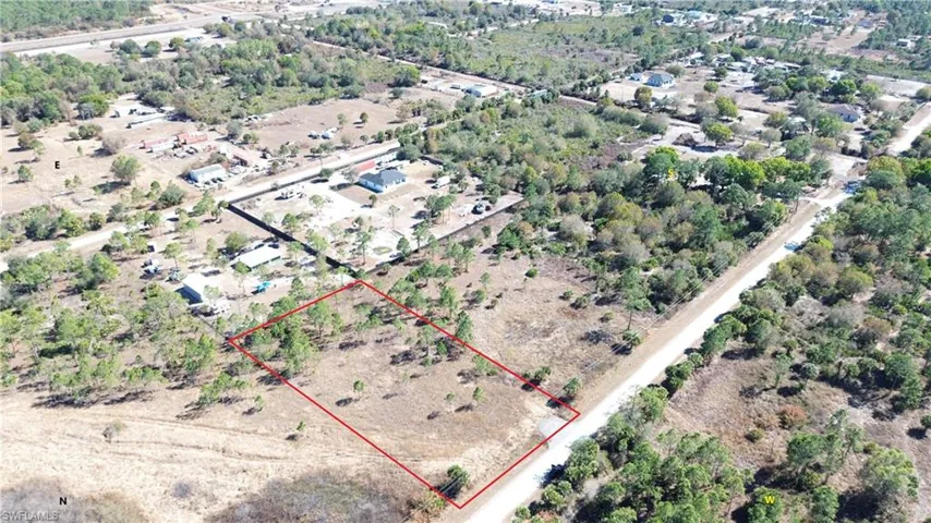 Aerial view of property and surrounding area with property parcel outlined