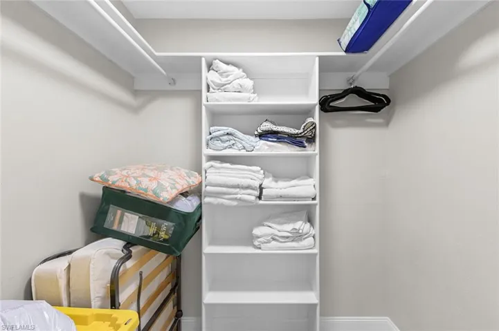 Built-in white shelving, integrated hanging rod, and painted walls