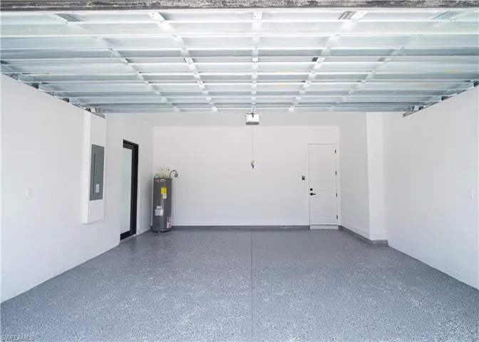 Garage with water heater and electric panel