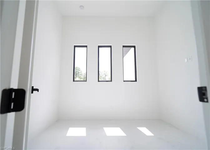 Unfurnished room with marble look tile flooring