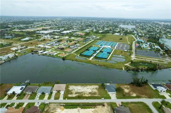 View of property location featuring a large body of water and nearby suburban area
