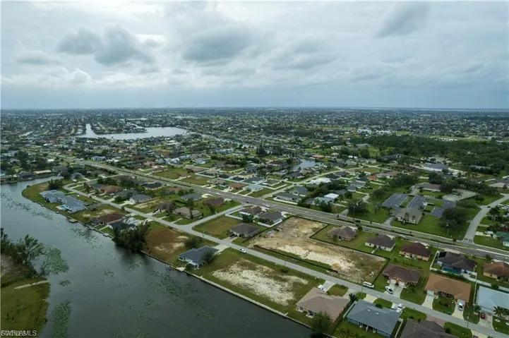 Aerial view of residential area featuring a nearby body of water