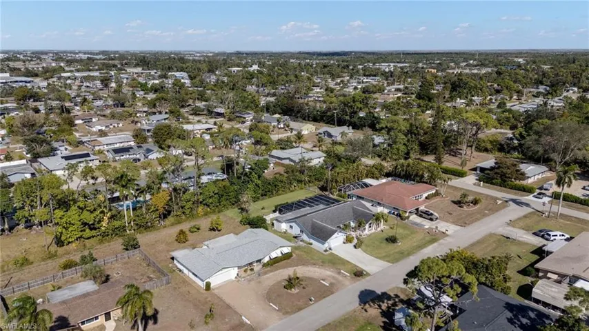 Aerial view of property's location with nearby suburban area