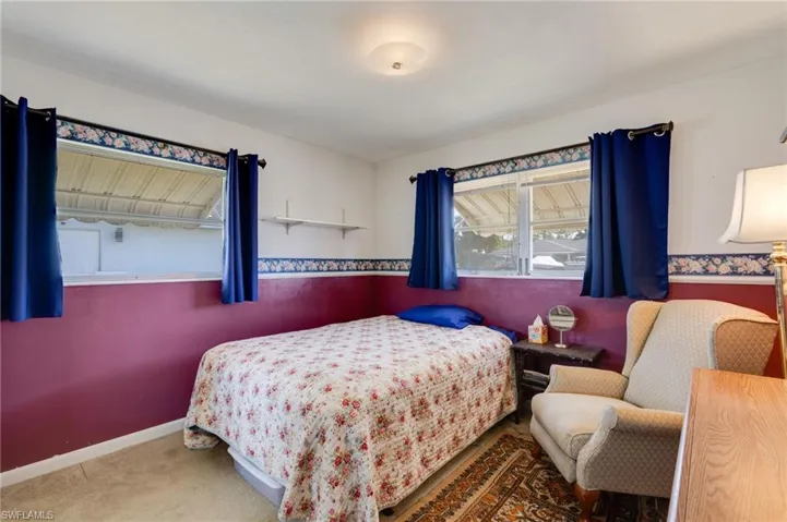 Carpeted bedroom featuring baseboards