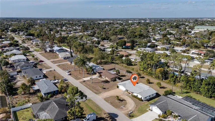 Aerial view of property's location with nearby suburban area