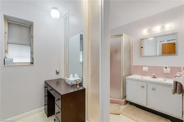 Bathroom featuring vanity and a stall shower