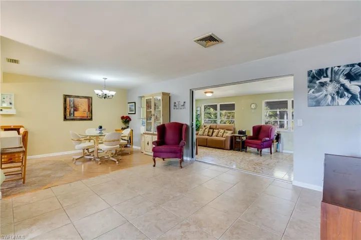 Living room featuring a chandelier and light tile patterned flooring