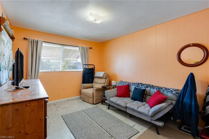 Living area with baseboards and light floors