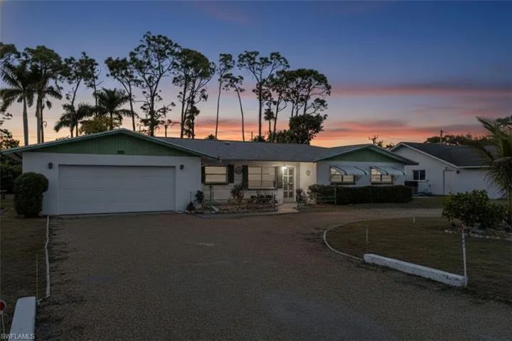 Single story home featuring driveway and an attached garage