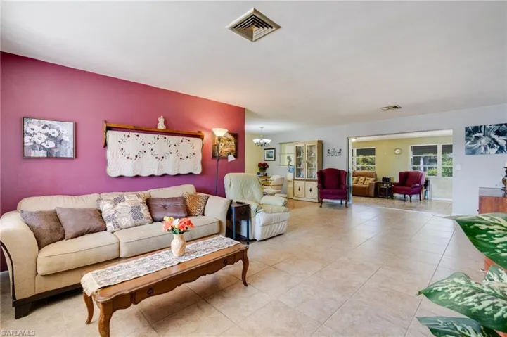 Tiled living area with a chandelier