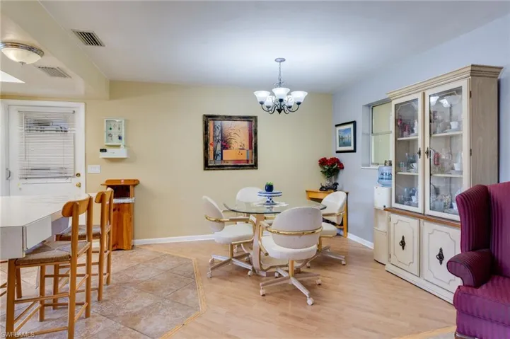 Dining room with a chandelier and light wood-type flooring