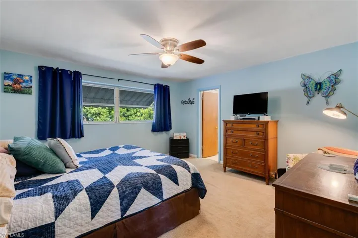 Bedroom featuring carpet and ceiling fan