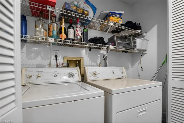 Washroom featuring washing machine and dryer