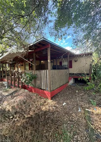Covered porch featuring wood-post supports and vertical wood railing