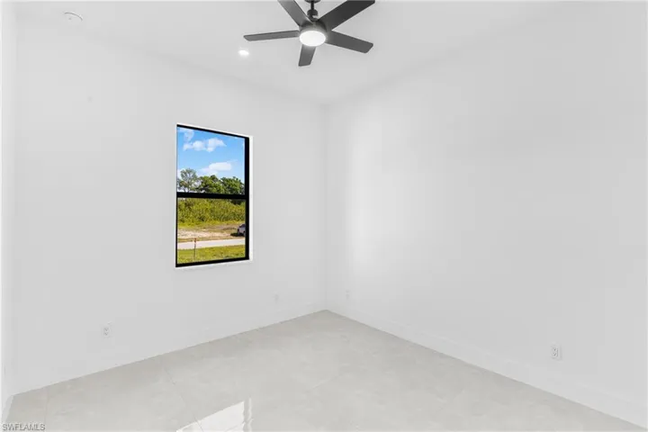 Spare room featuring ceiling fan, light tile patterned floors, and recessed lighting