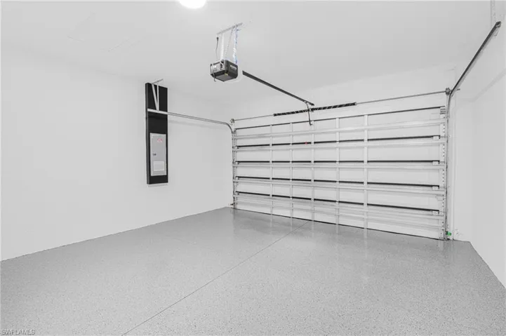 Garage with a garage door opener and electric panel