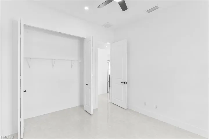 Unfurnished bedroom featuring ceiling fan, recessed lighting, a closet, and light tile patterned flooring