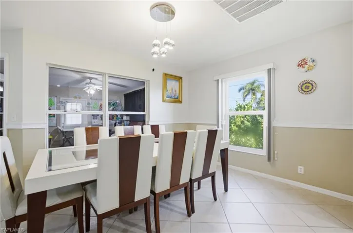 Dining space with ceiling fan and hanging lights