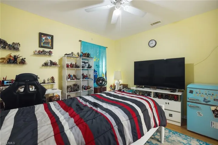 Bedroom featuring wood finished floors and a ceiling fan