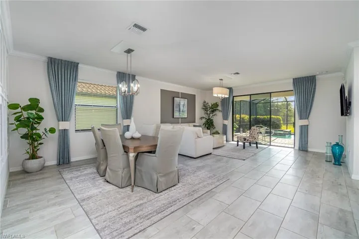 Dining area featuring crown molding and a chandelier