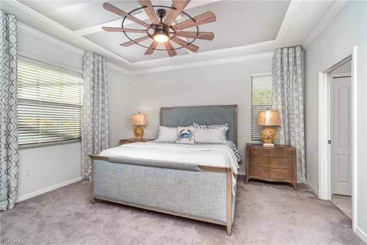 Bedroom with carpet flooring, ornamental molding, and ceiling fan