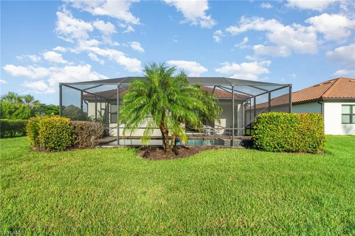 Back of property with a lawn
