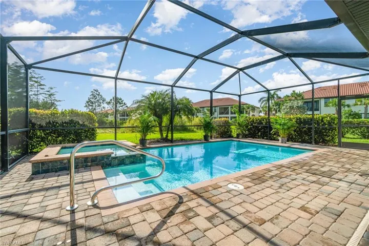 View of swimming pool with a patio and a pool with connected hot tub
