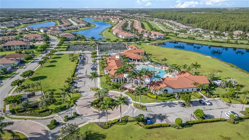 Aerial view of residential area featuring a nearby body of water