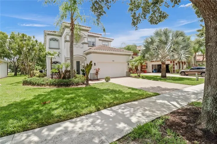Mediterranean / spanish house with a front yard