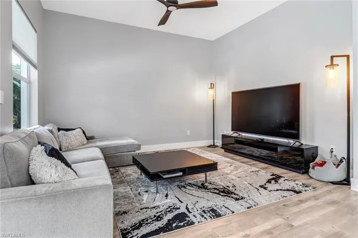 Living room with ceiling fan and light wood-type flooring