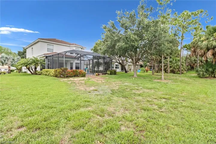 View of yard featuring glass enclosure